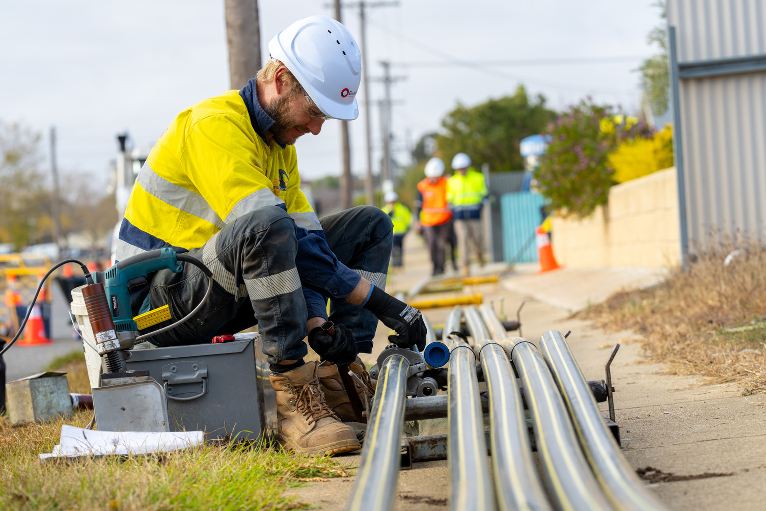 A gas worker in high vis working on a gas pipe