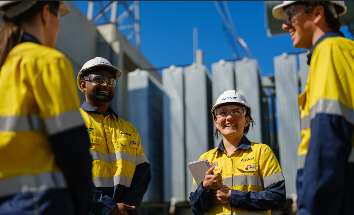 A group of people in hi-vis talking together outside