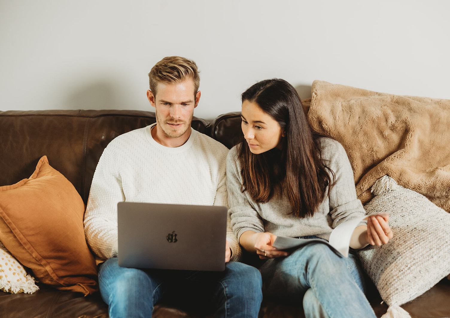 Two people looking at a laptop screen