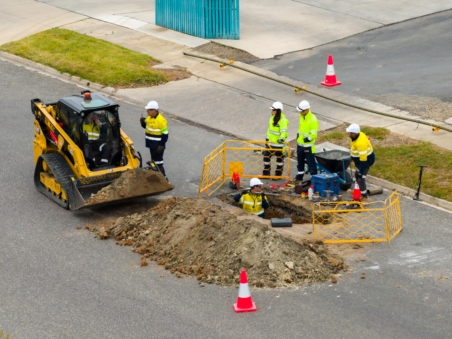 A group of people on a street working on gas lines