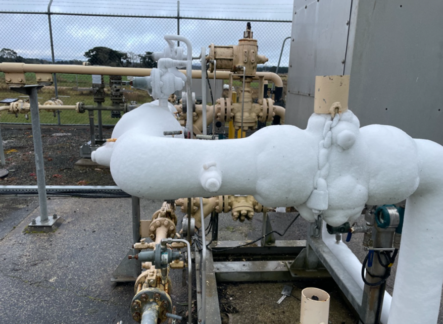 outdoor gas piping covered in thick layer of ice